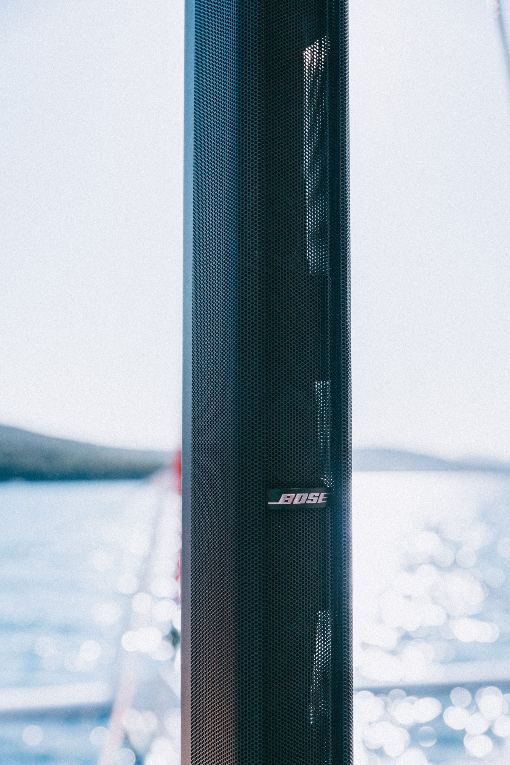 Bose F1 speaker close-up on yacht deck with Adriatic sea bokeh in background