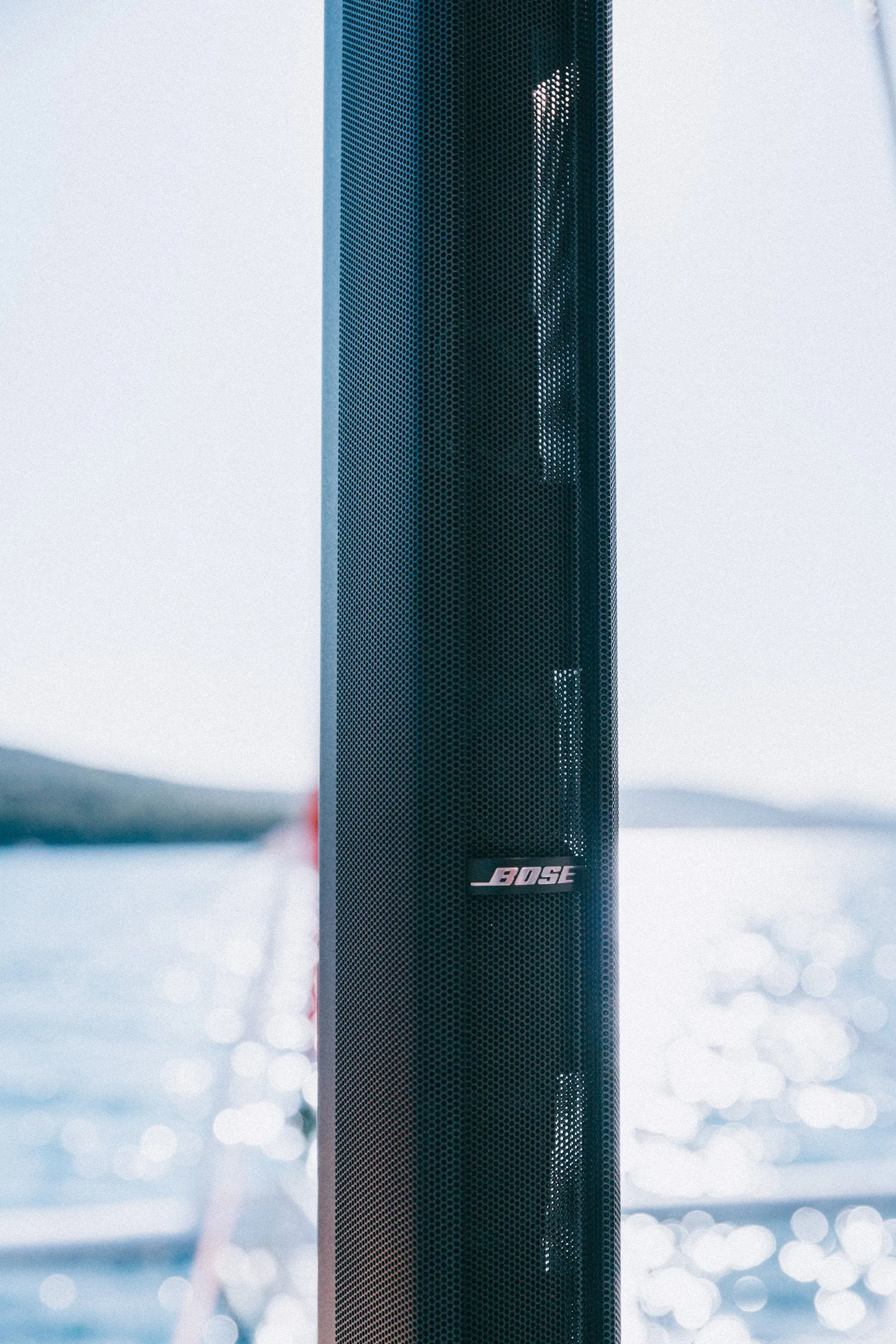 Bose F1 speaker on a yacht deck with Adriatic Sea — Cosmic Production marine audio
