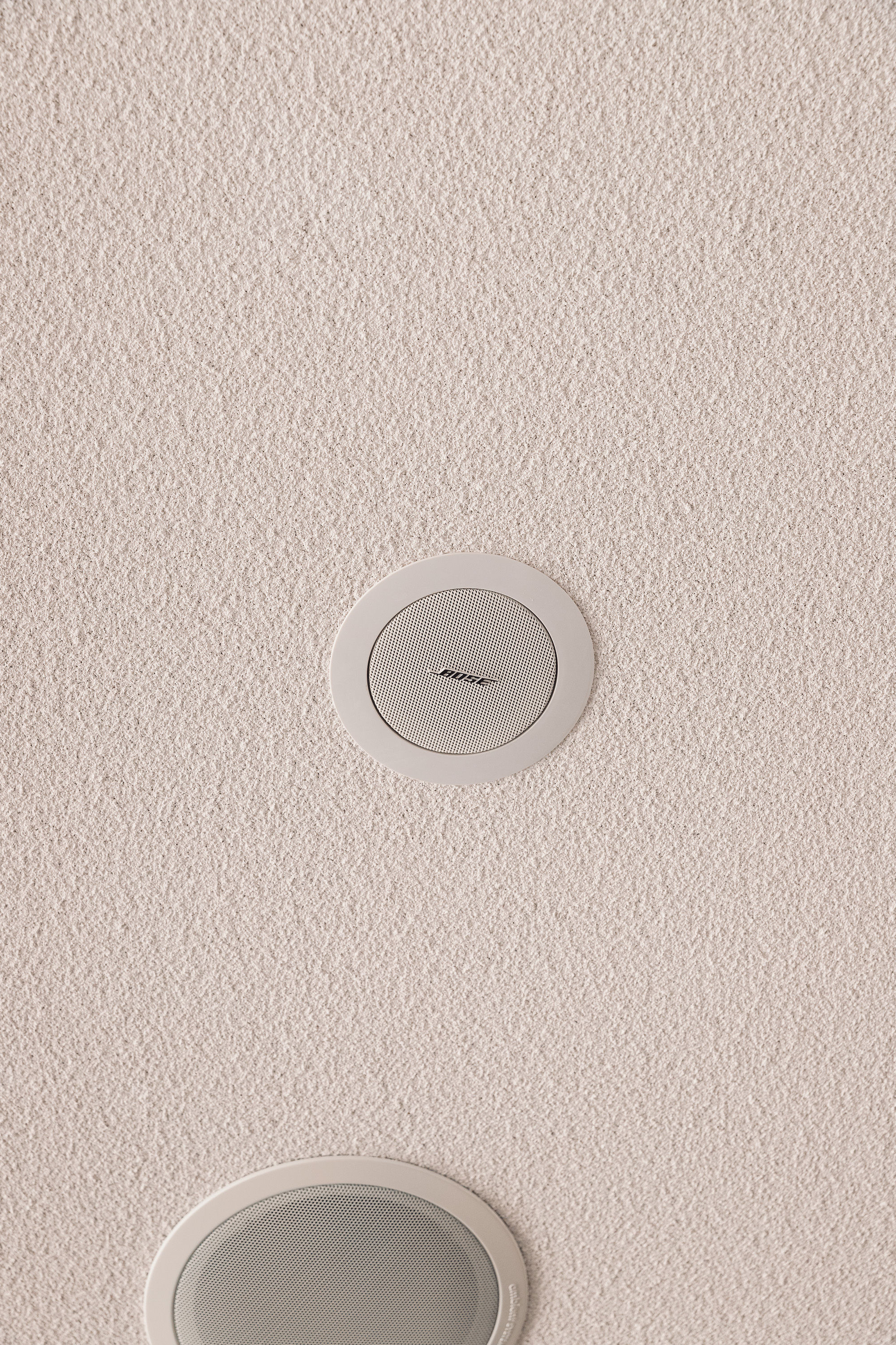 Bose flush-mount ceiling speaker close-up showing logo
