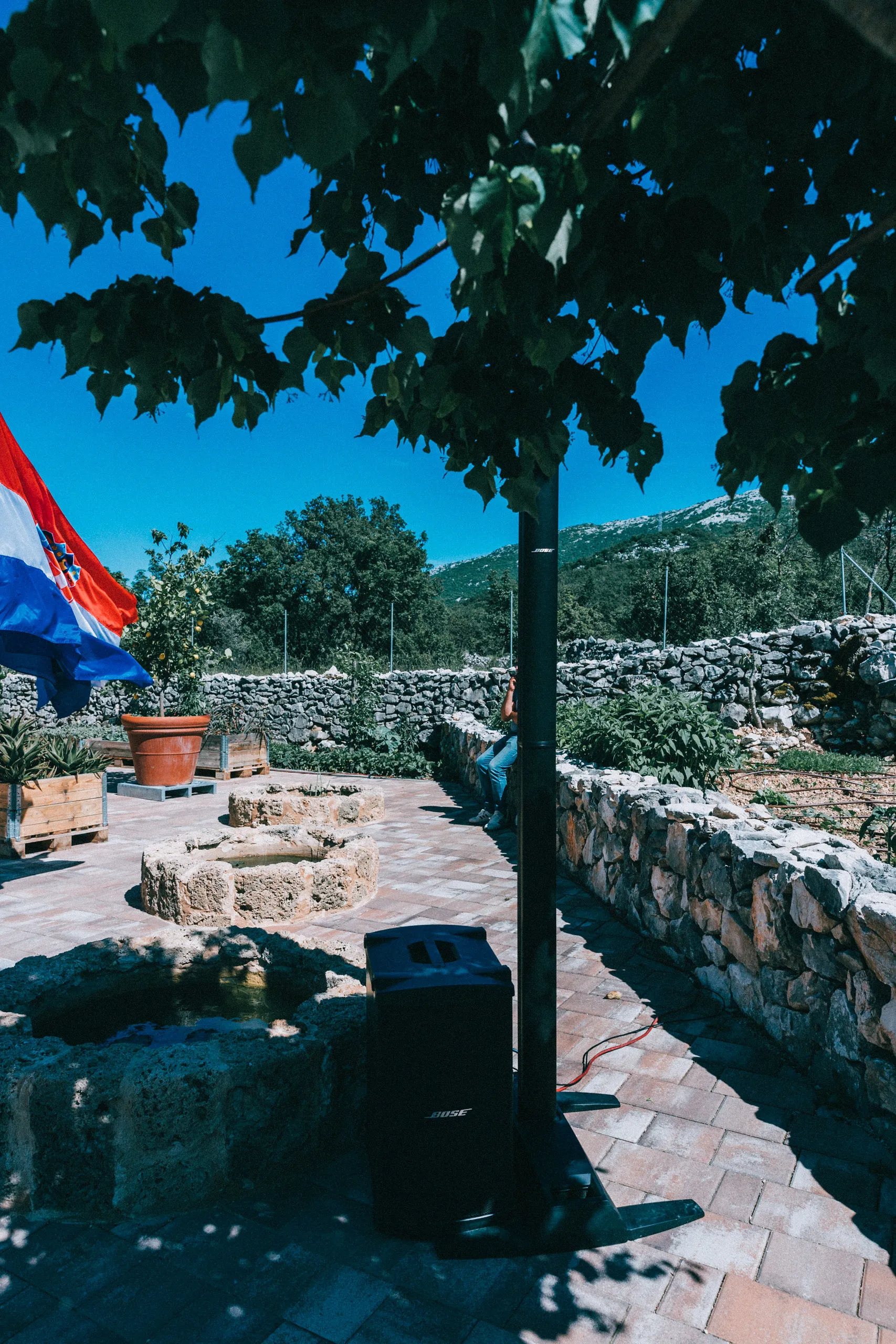 Bose speaker blending into a Dalmatian stone courtyard at a villa installation by Cosmic Production
