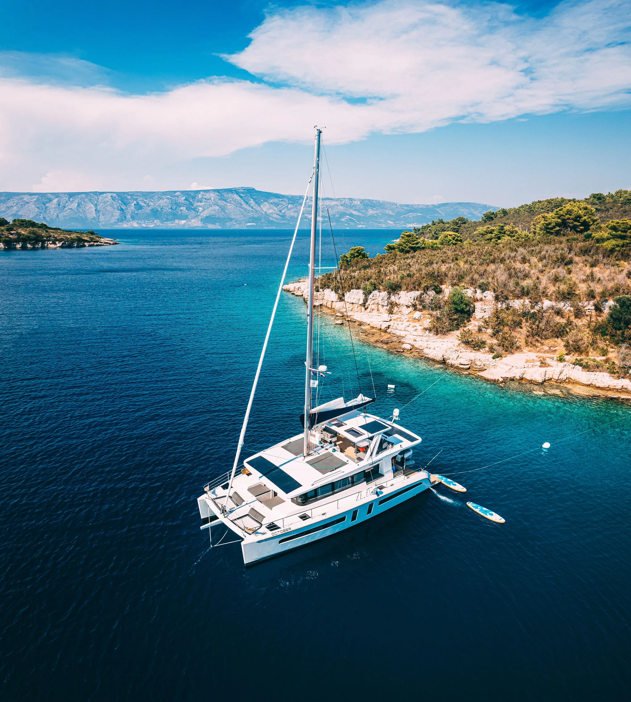 Catamaran anchored in an Adriatic bay drone aerial view — Cosmic Production yacht audio