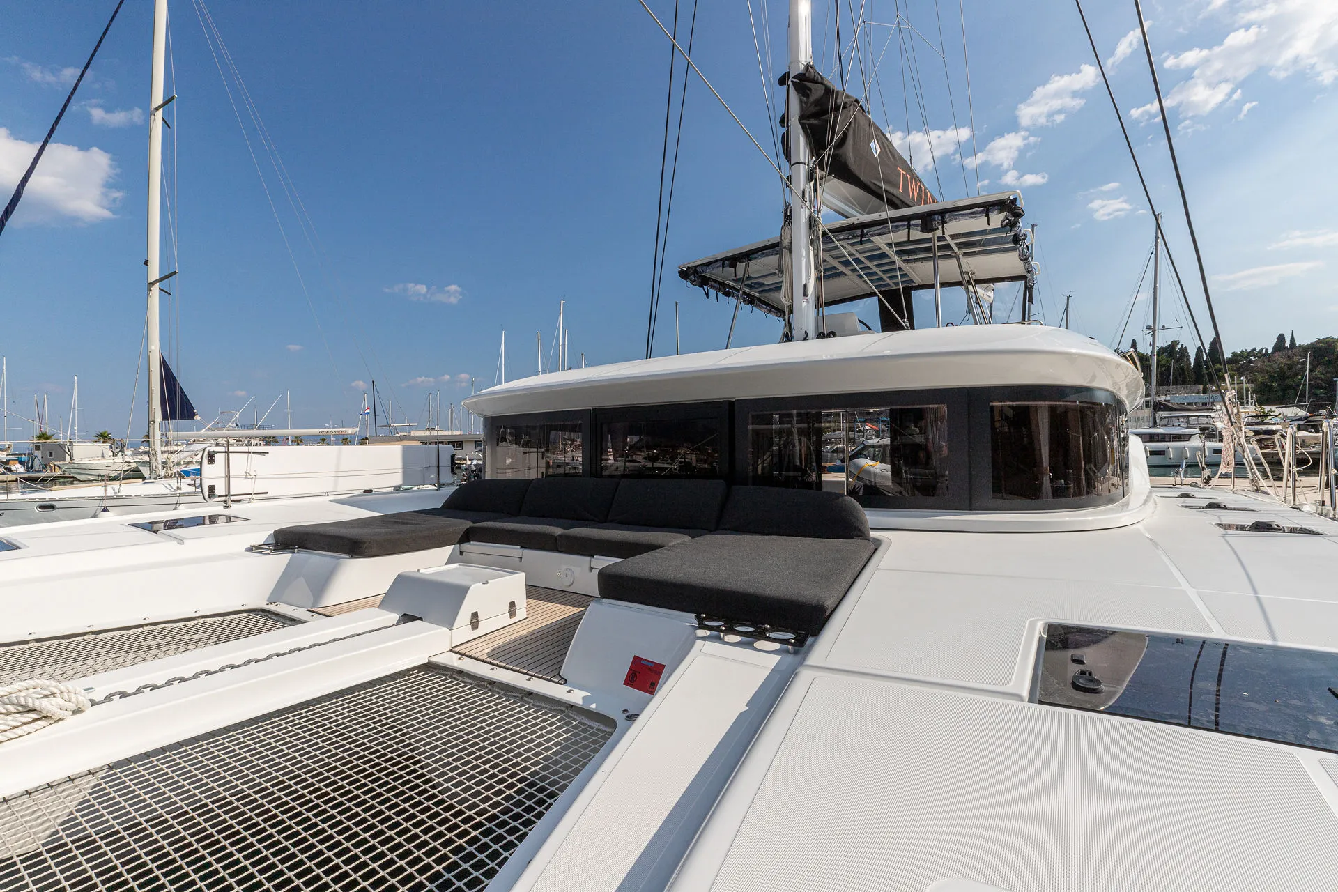 Catamaran deck lounge area on the Adriatic with guests — Cosmic Production yacht events