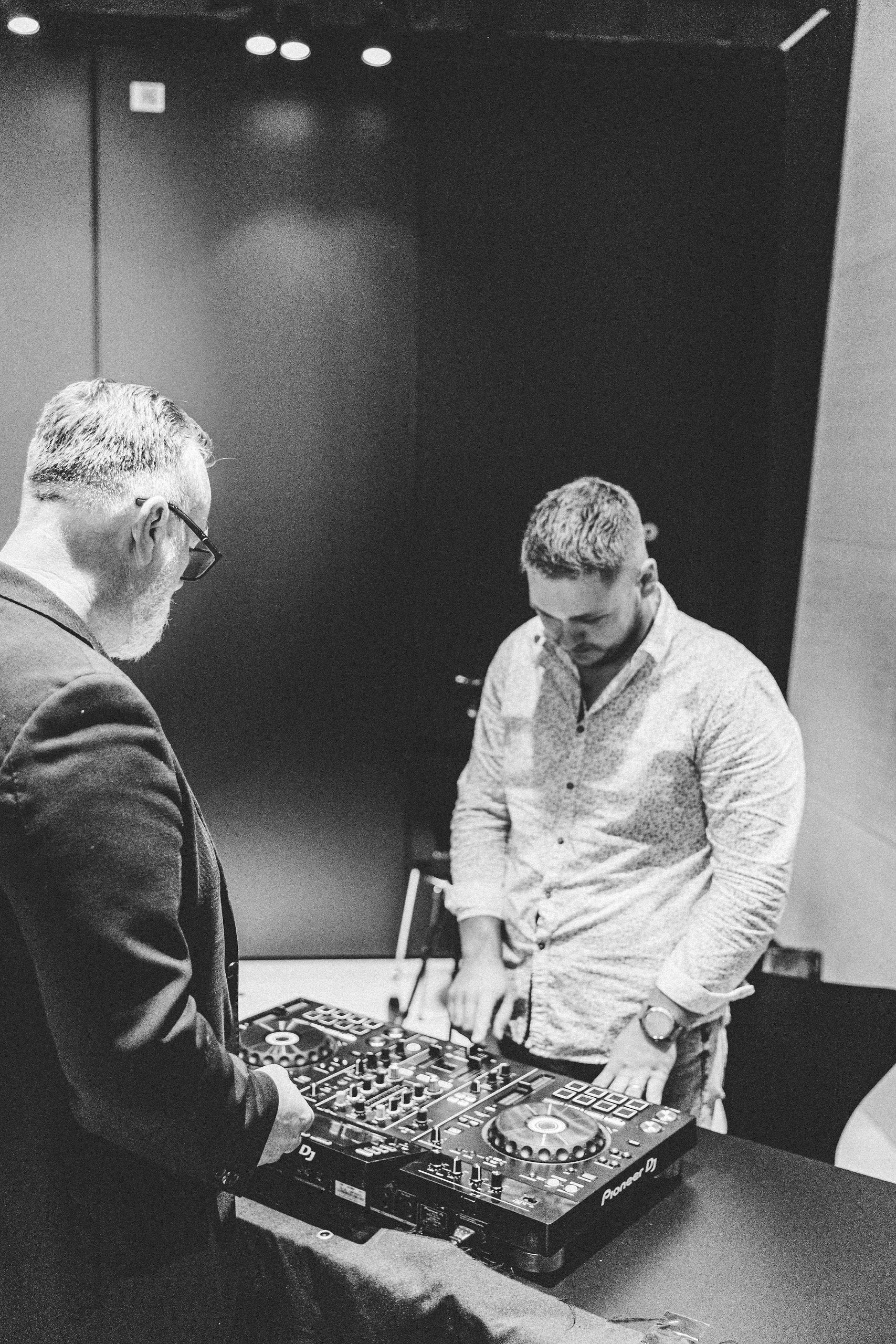 Matthew Bee mentoring a student at Pioneer DJ controller during hands-on training session