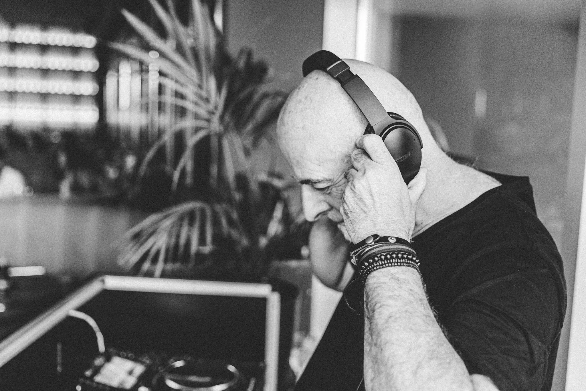 Music Selector listening through headphones in black and white — Cosmic Production DJ