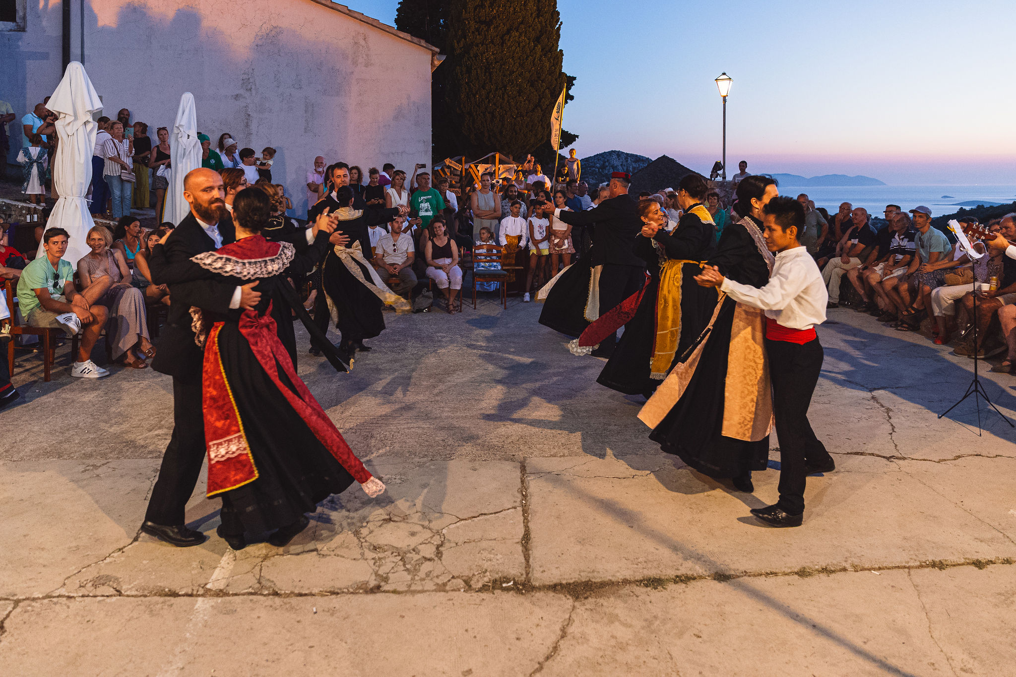 Traditional folk waltz at sunset during Hvar wedding celebration