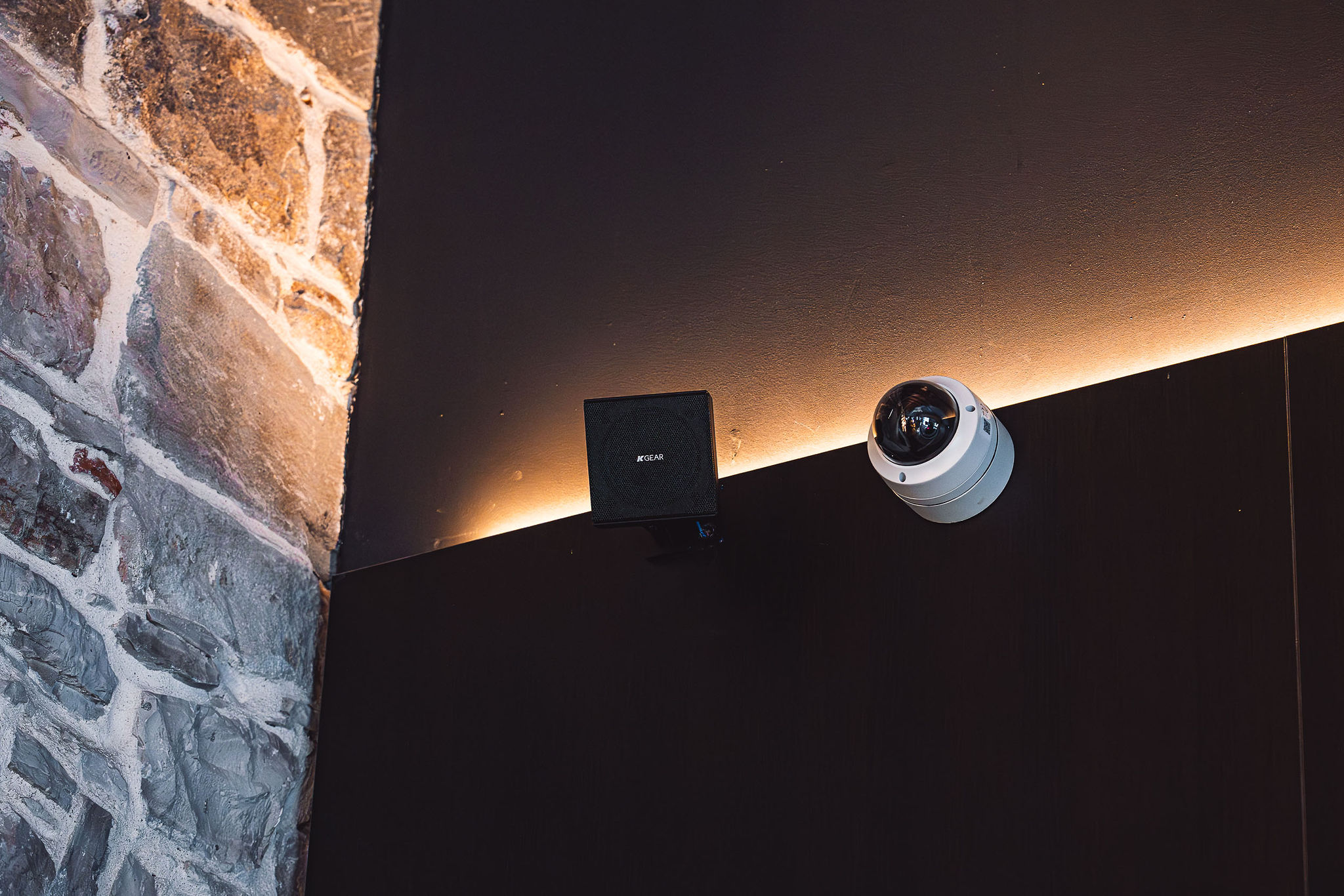 K-Gear speaker wall-mounted against Dalmatian stone wall at Bar Sistema in Split Old Town