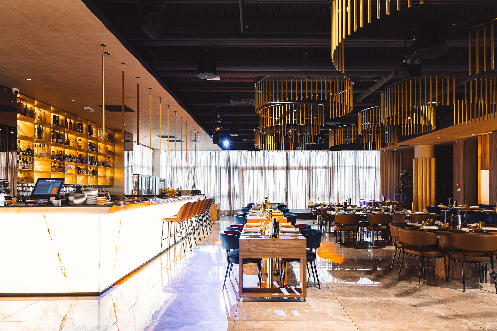 Level Restaurant Split full interior with Bose pendant speakers, Fresnel stage lights, and gold chandeliers — complete AV integration by Cosmic Production