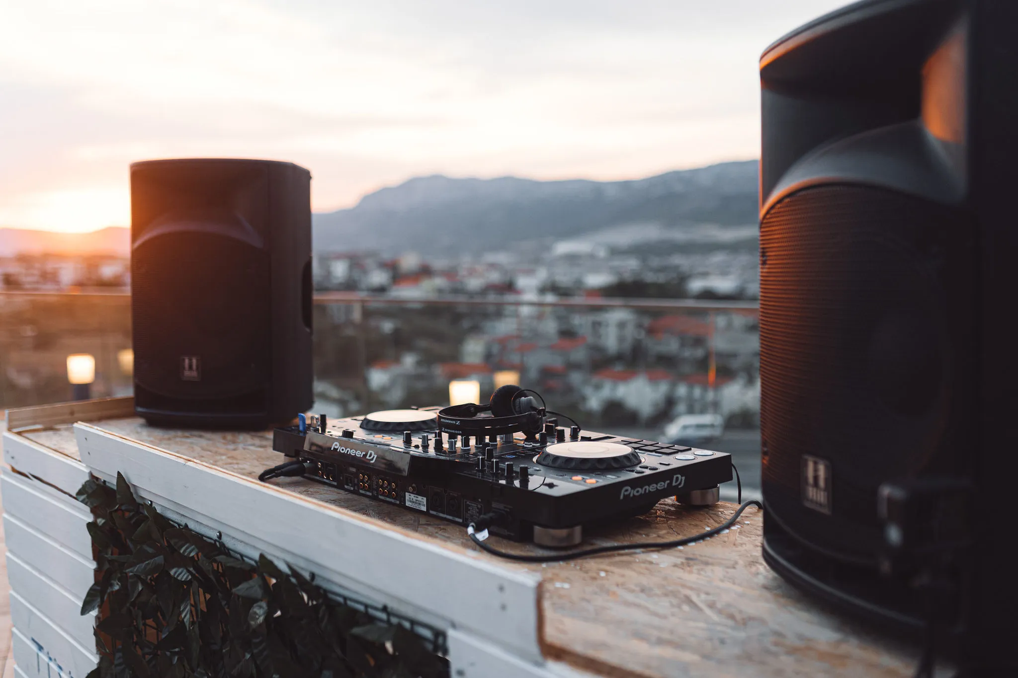 Pioneer DJ controller and speakers set up on a rooftop terrace at sunset in Split by Cosmic Production