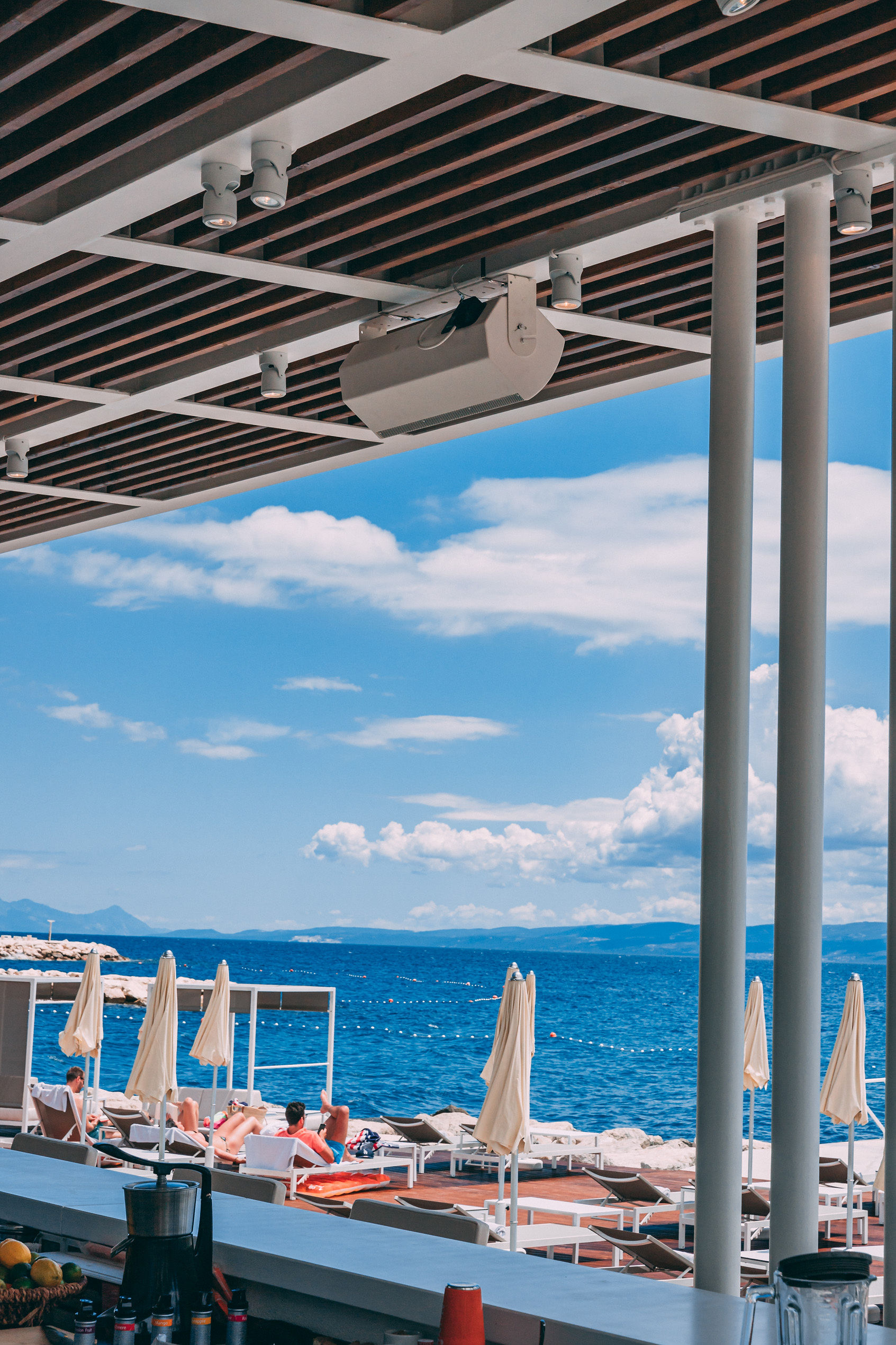 Bose speaker on ceiling at Mistral Beach Bar with Adriatic sea view through the bar at Radisson Blu Split