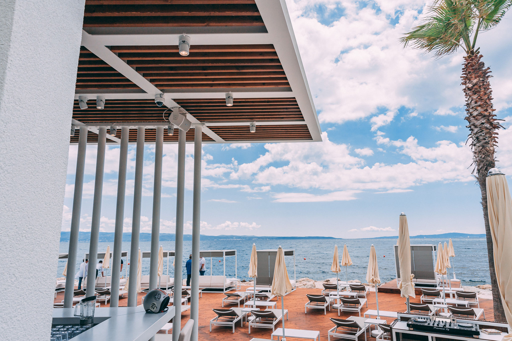 Pioneer DJ equipment at hotel beach bar counter with palm tree and Adriatic sea view at Radisson Blu Split