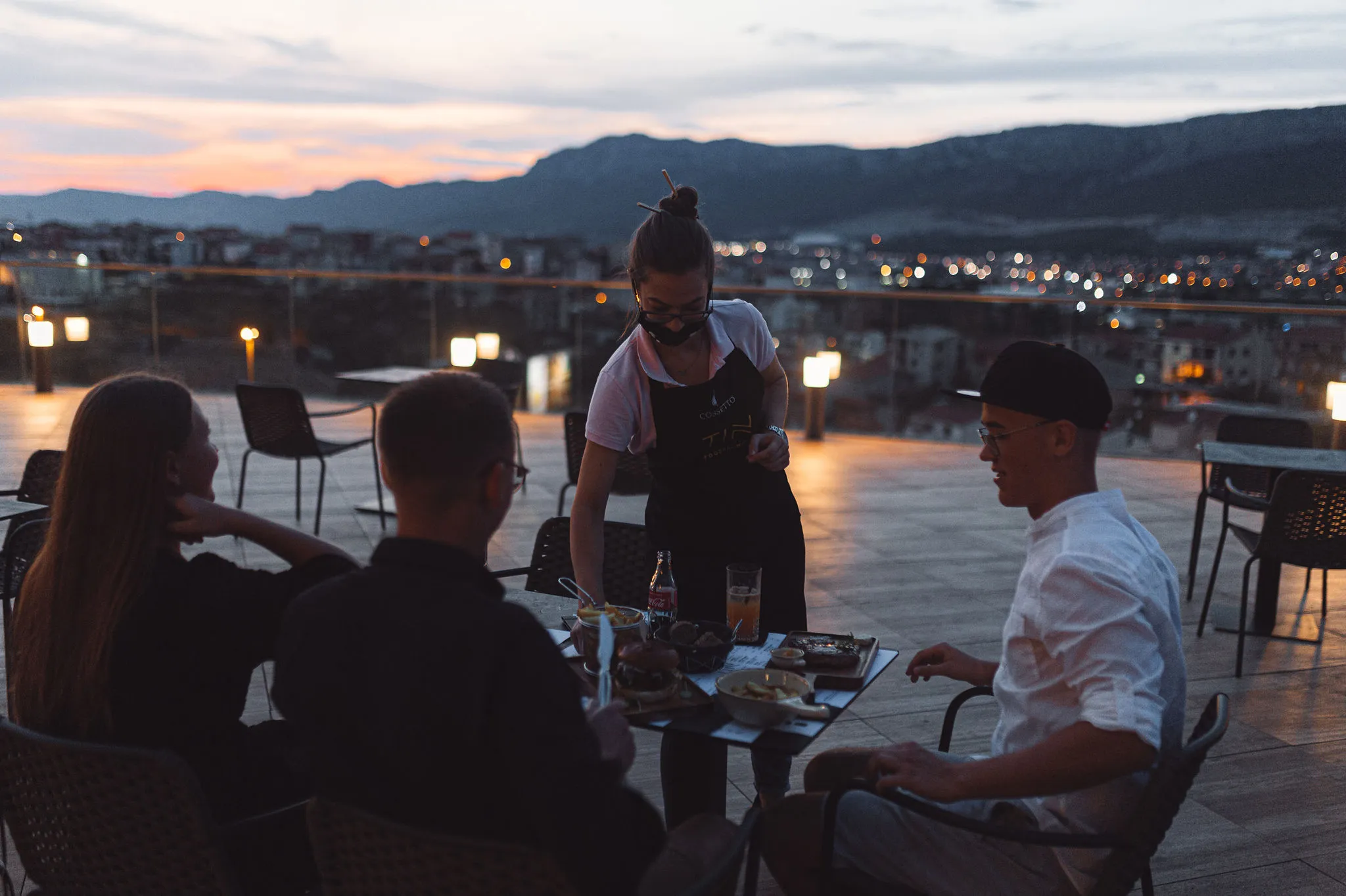 Rooftop restaurant DJ residency with diners enjoying sunset views in Split