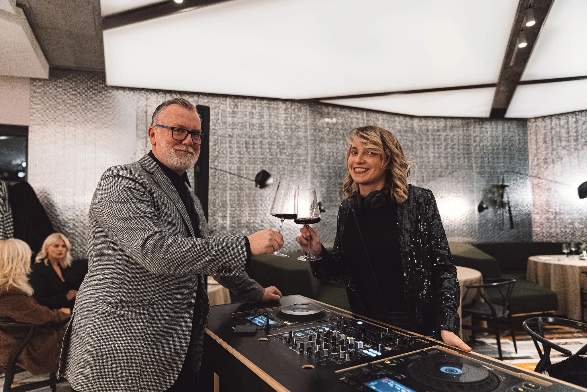 Wine toast with DJ booth in background at a Croatian winery wedding event by Cosmic Production